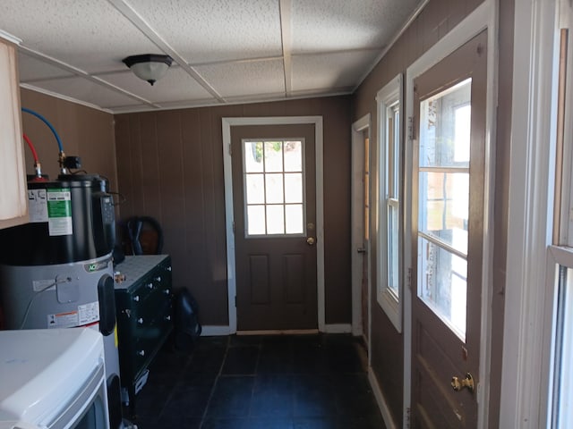 entryway with water heater and wooden walls