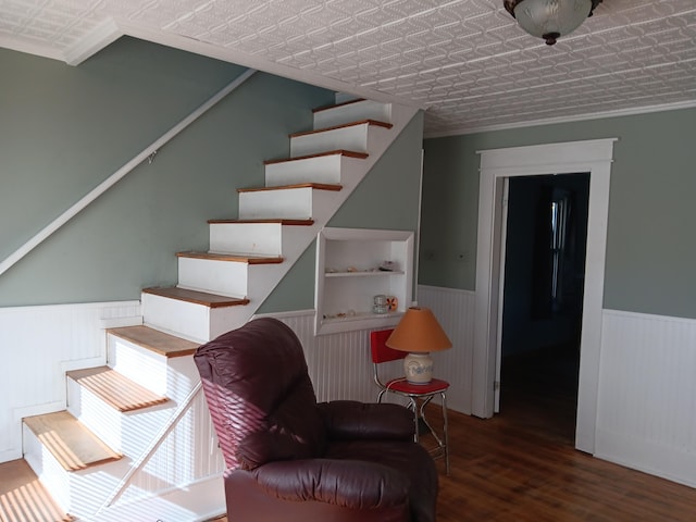 stairway with lofted ceiling, a textured ceiling, and wood-type flooring