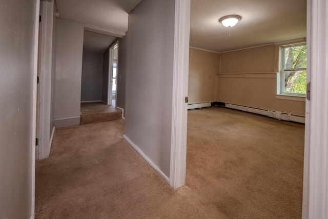 hallway featuring baseboard heating and light colored carpet