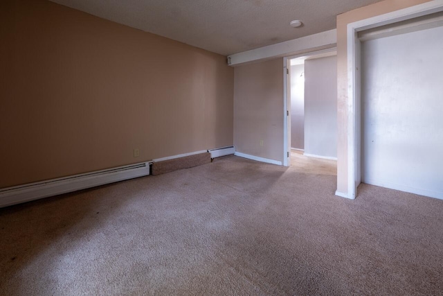 unfurnished room featuring light carpet, a textured ceiling, and a baseboard heating unit