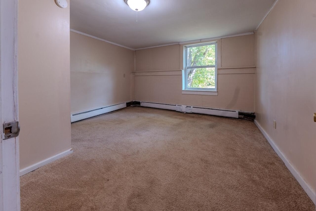 spare room with baseboard heating, crown molding, and light colored carpet