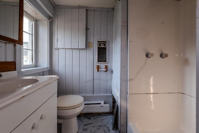 bathroom featuring wooden walls, vanity, and toilet