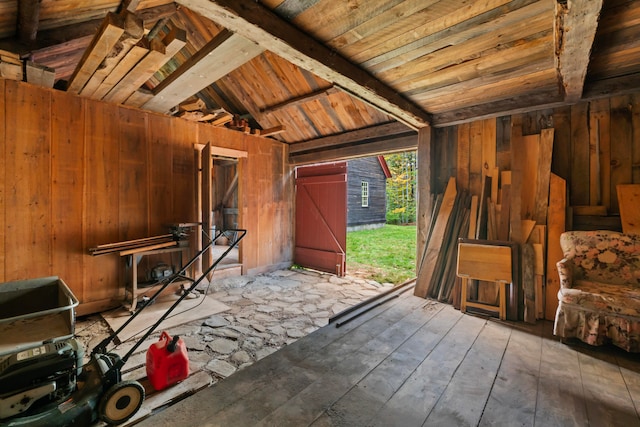 miscellaneous room with wood walls, wood-type flooring, wooden ceiling, and lofted ceiling with beams