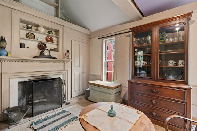 sitting room with lofted ceiling