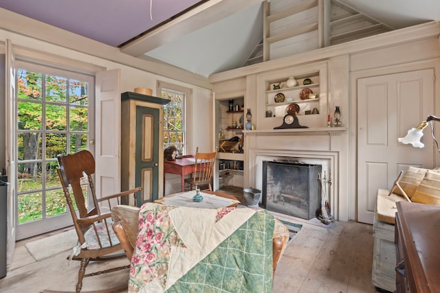 dining space featuring wood-type flooring and vaulted ceiling