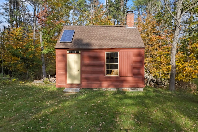 view of outbuilding with a lawn