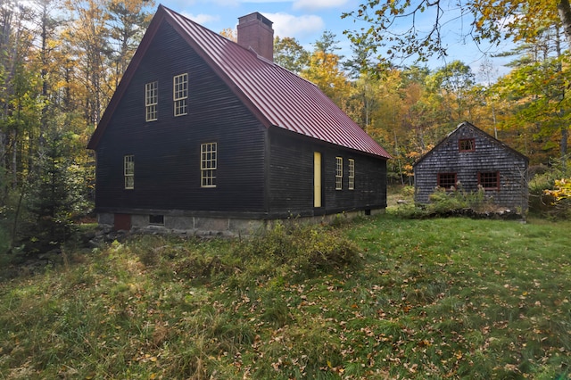 view of side of home with a yard