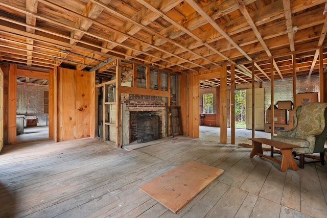 misc room featuring a brick fireplace and light hardwood / wood-style flooring