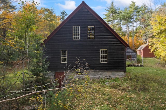 view of side of home featuring a yard