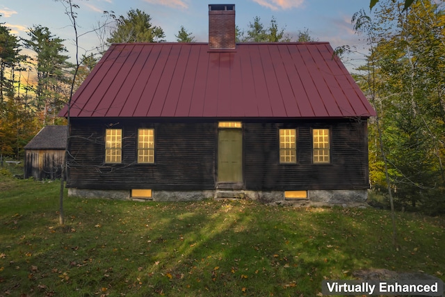 back house at dusk with a yard