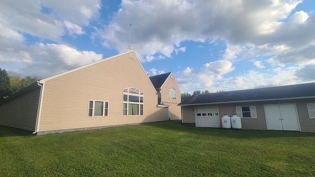 view of home's exterior featuring a lawn and a garage