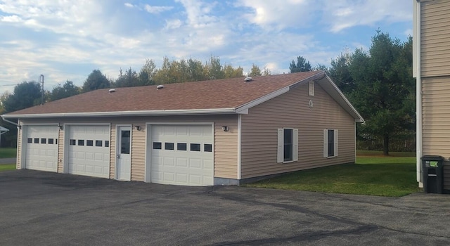 view of property exterior with a lawn and a garage