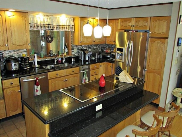 kitchen featuring sink, hanging light fixtures, decorative backsplash, stainless steel appliances, and light tile patterned floors