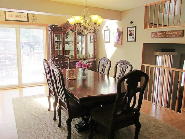 dining space featuring a notable chandelier and wood finished floors