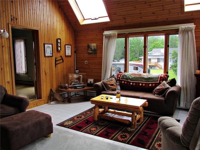 living room featuring high vaulted ceiling, wood walls, a skylight, and tile patterned floors