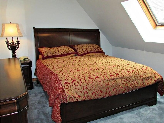 bedroom featuring dark colored carpet and lofted ceiling with skylight