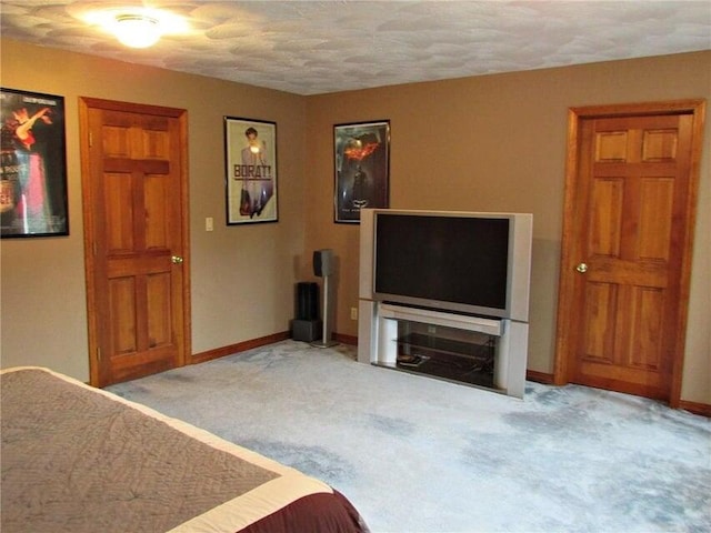 carpeted bedroom featuring a textured ceiling