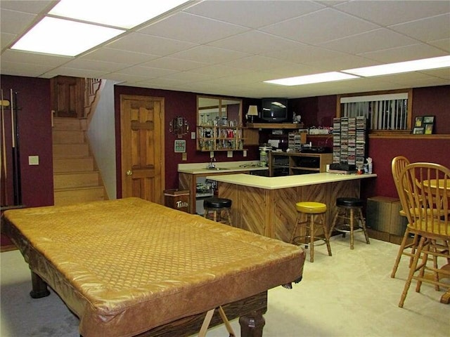 recreation room with pool table, a paneled ceiling, and bar