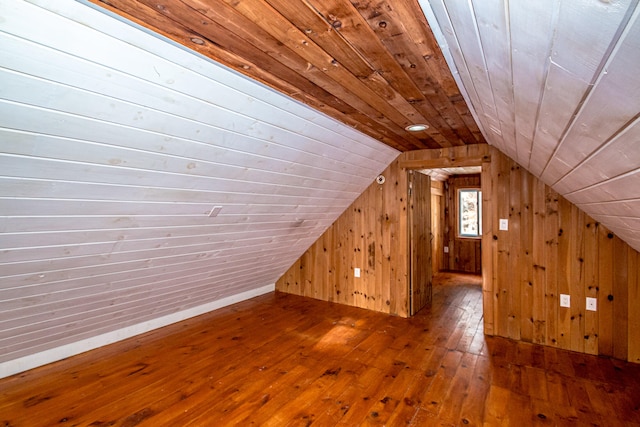 bonus room featuring hardwood / wood-style floors, wood walls, lofted ceiling, and wooden ceiling