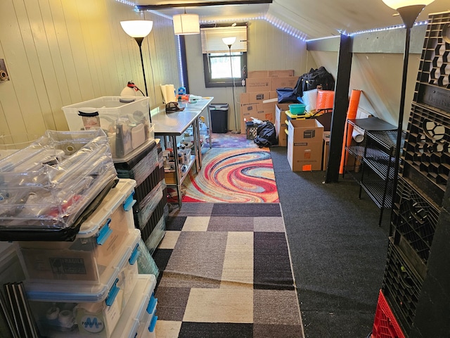 interior space featuring carpet and wood walls