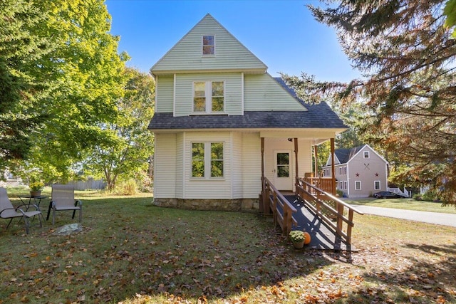 rear view of property featuring a yard