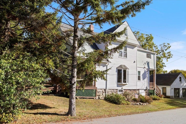 view of side of property with a lawn