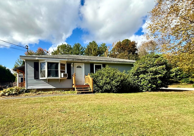 view of front of house featuring cooling unit and a front lawn