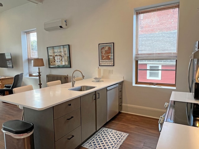 30 Water St, Ellsworth, ME 04605 - kitchen featuring a wall unit AC, kitchen peninsula, dark hardwood / wood-style floors, stainless steel appliances, and sink