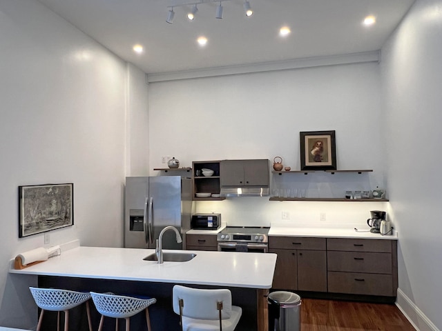30 Water St, Ellsworth, ME 04605 - kitchen featuring a breakfast bar area, kitchen peninsula, and stainless steel appliances