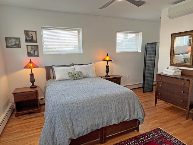 30 Water St, Ellsworth, ME 04605 - bedroom with ceiling fan, a baseboard heating unit, a wall mounted air conditioner, and light hardwood / wood-style floors