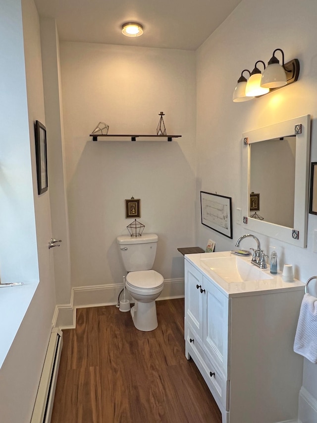 30 Water St, Ellsworth, ME 04605 - bathroom with toilet, vanity, wood-type flooring, and a baseboard radiator