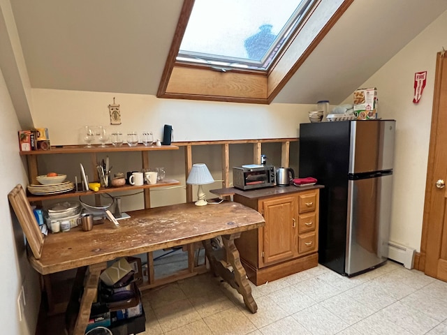 30 Water St, Ellsworth, ME 04605 - kitchen featuring lofted ceiling with skylight, stainless steel fridge, and a baseboard heating unit