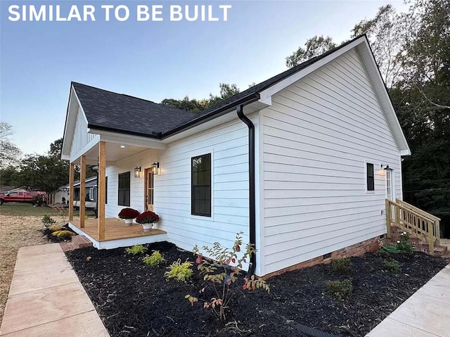 view of side of property with a porch