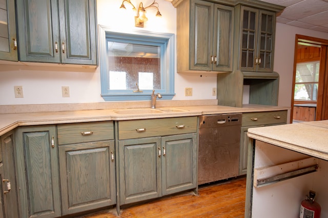 kitchen featuring dishwasher, light wood-type flooring, sink, and a wealth of natural light