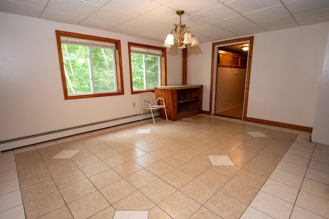 tiled empty room with a notable chandelier and a baseboard heating unit