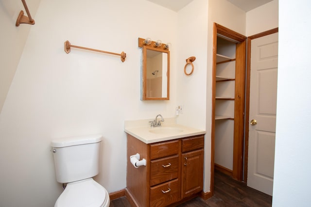 bathroom featuring vanity, toilet, and hardwood / wood-style flooring