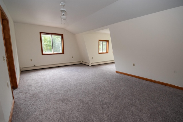 additional living space featuring vaulted ceiling and carpet