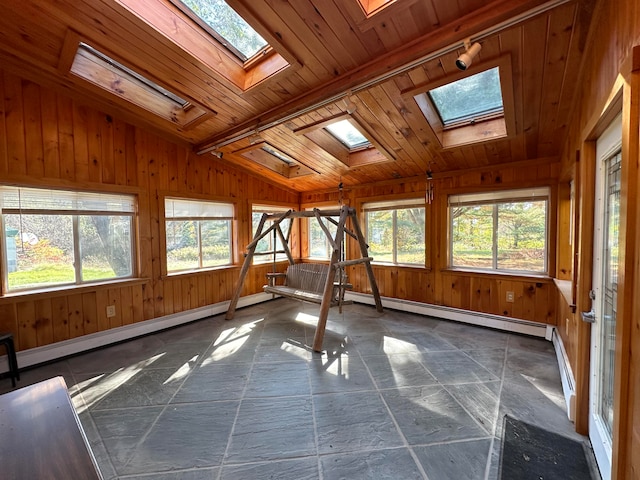 unfurnished sunroom with lofted ceiling with skylight, plenty of natural light, wood ceiling, and baseboard heating