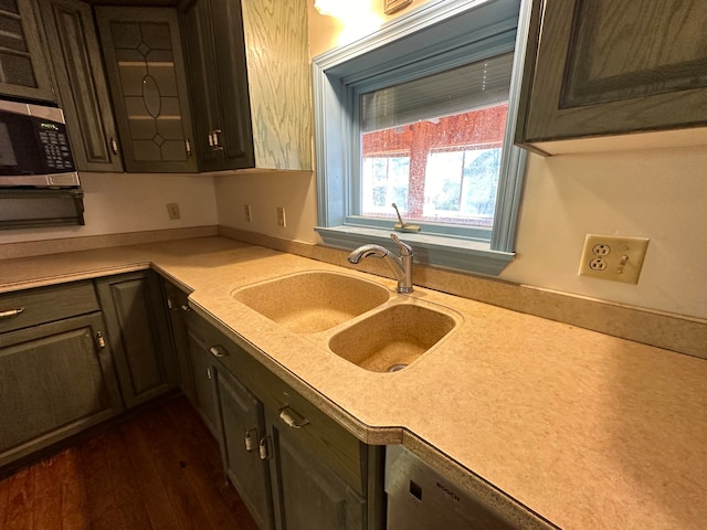 kitchen with dark wood-type flooring, sink, and dark brown cabinets