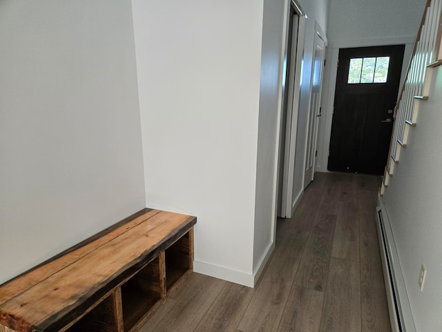 corridor featuring a baseboard radiator and dark wood-type flooring