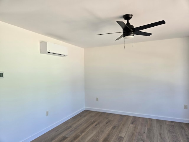 empty room featuring a wall unit AC, ceiling fan, and dark hardwood / wood-style flooring