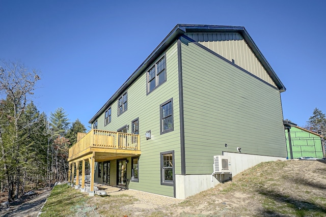 back of property featuring a wooden deck