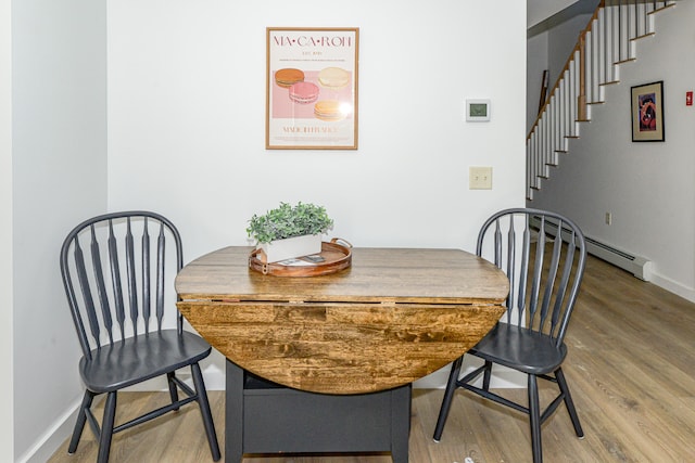 dining room featuring hardwood / wood-style flooring and a baseboard radiator