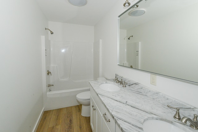 full bathroom featuring  shower combination, hardwood / wood-style flooring, vanity, and toilet