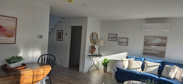 living room featuring a wall unit AC and hardwood / wood-style flooring