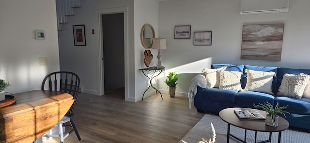 living room with hardwood / wood-style floors and a wall unit AC