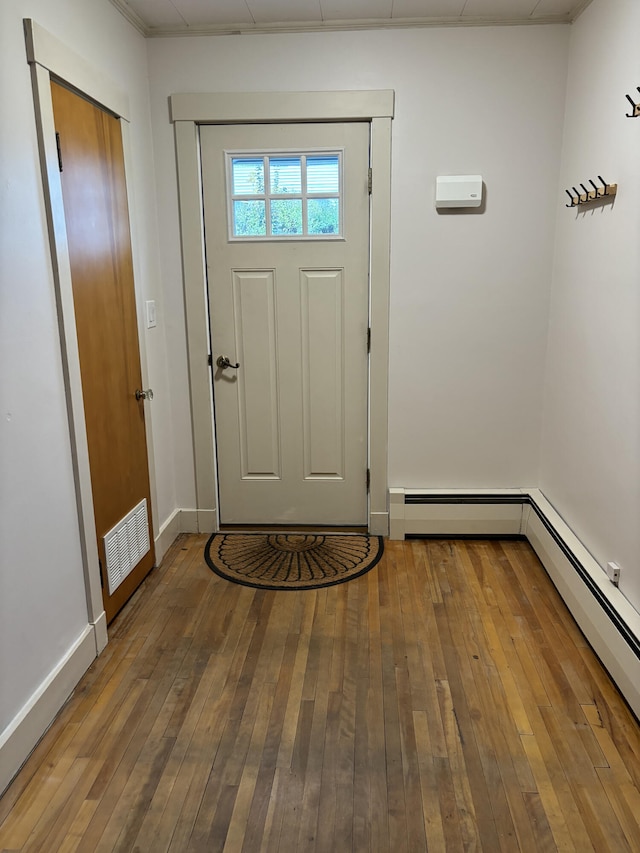 entrance foyer with wood-type flooring and baseboard heating