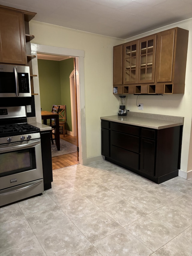 kitchen featuring light hardwood / wood-style floors, dark brown cabinets, and stainless steel appliances