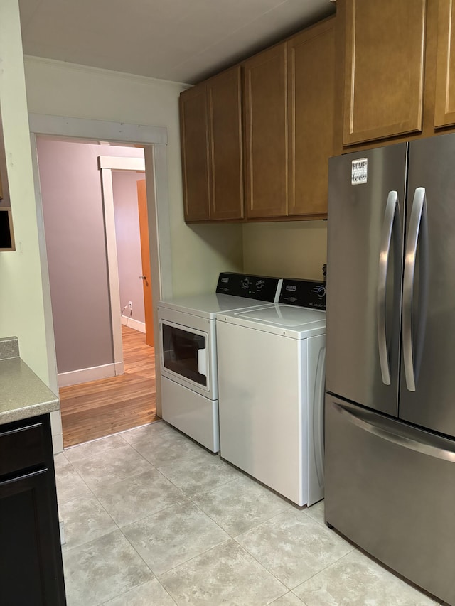 laundry room featuring light hardwood / wood-style floors and washer and dryer