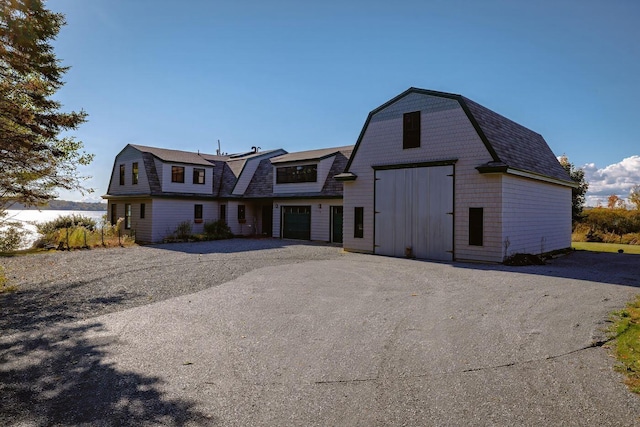 65 Grange Hall Rd, Sullivan, ME 04664 - colonial inspired home featuring an outbuilding, a gambrel roof, a barn, and driveway